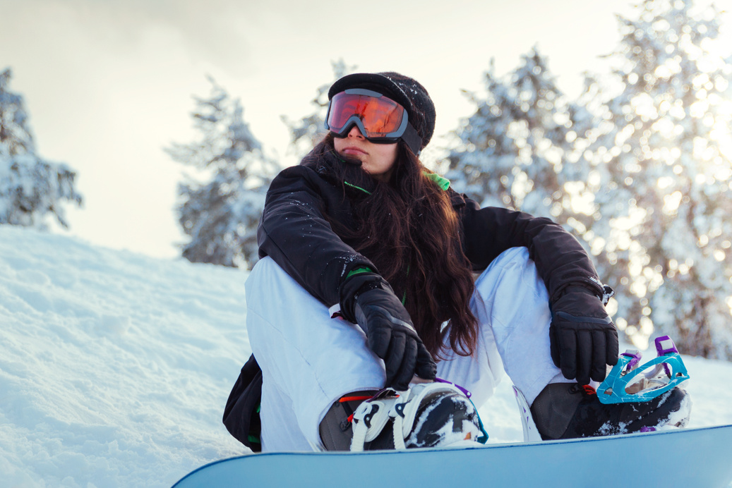 Woman Snowboarder Sitting on the Snow