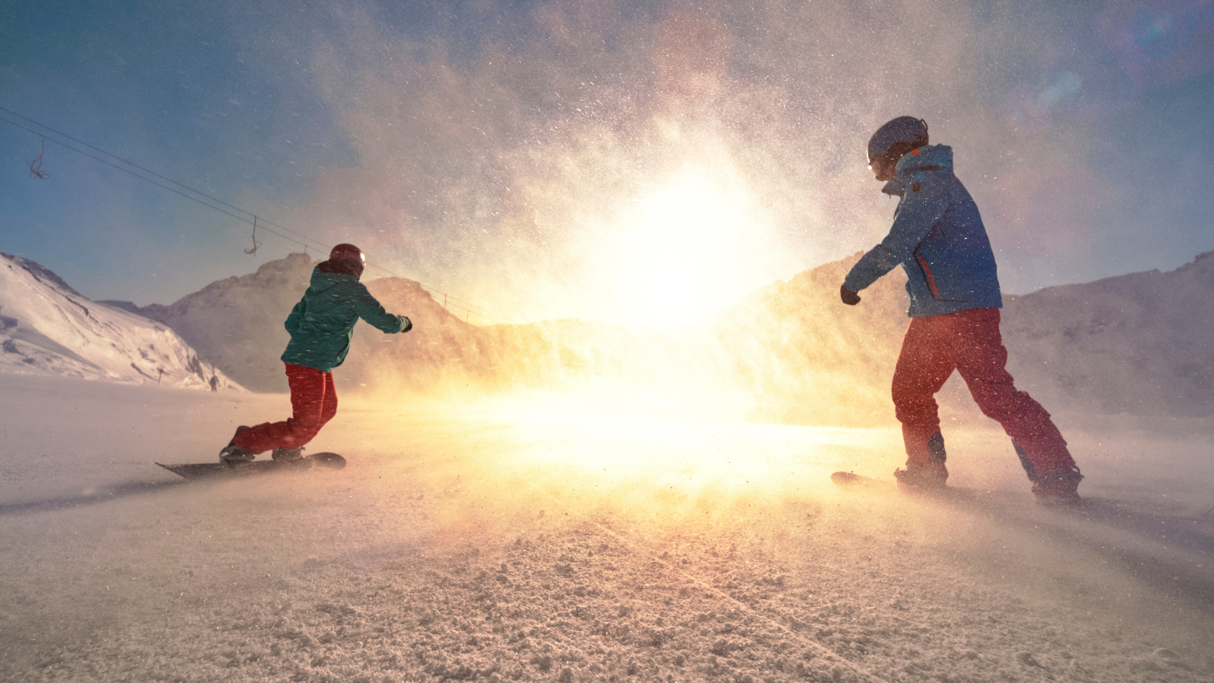 Man and woman snowboarding on mountain